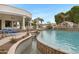 Resort-style pool featuring a rock waterfall, built-in seating, and access to the outdoor living space at 321 N Portland Ave, Gilbert, AZ 85234