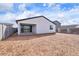 An expansive backyard features a covered patio with sliding glass doors, ready for your landscaping and design ideas at 4312 E Bradford Ave, San Tan Valley, AZ 85143