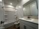 Bright bathroom features a vanity with a white countertop and a shower-tub combo at 4312 E Bradford Ave, San Tan Valley, AZ 85143