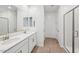 A bright bathroom features double sinks, wood-look tile floors, and a glass-enclosed shower at 4312 E Bradford Ave, San Tan Valley, AZ 85143