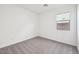Clean bedroom with neutral carpet, window, and fresh white walls at 4312 E Bradford Ave, San Tan Valley, AZ 85143