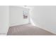 A bright bedroom features neutral carpeting and a window at 4312 E Bradford Ave, San Tan Valley, AZ 85143