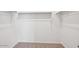 A bright, empty walk-in closet features a clothes-hanging bar and neutral carpeting at 4312 E Bradford Ave, San Tan Valley, AZ 85143