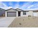 Charming single-story home featuring a well-manicured gravel front yard and a two-car garage at 4312 E Bradford Ave, San Tan Valley, AZ 85143