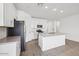 Contemporary kitchen featuring white cabinetry, stainless appliances, and an island with a sink at 4312 E Bradford Ave, San Tan Valley, AZ 85143