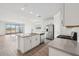 Bright kitchen boasting white cabinets, stainless steel appliances, and center island with seating at 4312 E Bradford Ave, San Tan Valley, AZ 85143