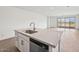 Kitchen island with stainless steel sink and dishwasher in open space layout at 4312 E Bradford Ave, San Tan Valley, AZ 85143