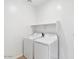 A bright laundry room features a white washer and dryer at 4312 E Bradford Ave, San Tan Valley, AZ 85143