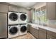 Bright laundry room with modern appliances and herringbone floor at 4802 N 46Th St, Phoenix, AZ 85018
