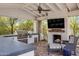 Outdoor kitchen with grill, fireplace, and seating area at 4802 N 46Th St, Phoenix, AZ 85018