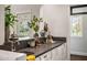 Modern wet bar with dark countertop and beverage storage at 4802 N 46Th St, Phoenix, AZ 85018