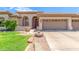 Beautiful home exterior with a two-car garage and manicured lawn at 5535 E Sheena Dr, Scottsdale, AZ 85254
