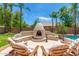 Charming outdoor fireplace with seating area perfect for relaxing at 5535 E Sheena Dr, Scottsdale, AZ 85254