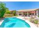 Inviting backyard oasis featuring a sparkling pool, patio, and lush landscaping at 5535 E Sheena Dr, Scottsdale, AZ 85254