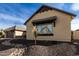 Light tan house with a brown roof and nicely landscaped yard at 7130 W Rowel Rd, Peoria, AZ 85383