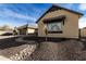 Light tan house with a brown roof and nicely landscaped yard at 7130 W Rowel Rd, Peoria, AZ 85383