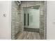 Glass-walled interior room with modern stone wall and wood-look flooring at 7130 W Rowel Rd, Peoria, AZ 85383