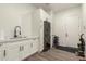 Bright laundry room with white cabinets, modern washer and dryer, and a utility sink at 7130 W Rowel Rd, Peoria, AZ 85383