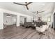 Open living area with hardwood floors, kitchen view, and sliding doors at 7130 W Rowel Rd, Peoria, AZ 85383