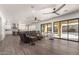 Open living room with hardwood floors, a view of the kitchen, and sliding doors to backyard at 7130 W Rowel Rd, Peoria, AZ 85383