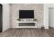Modern living room features a stone fireplace and built-in entertainment center at 7130 W Rowel Rd, Peoria, AZ 85383