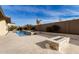 Luxury backyard oasis featuring a large pool, spa, and fire pit at 7130 W Rowel Rd, Peoria, AZ 85383