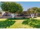 Landscaped backyard with large trees and patio access at 10322 W Manzanita Dr, Sun City, AZ 85373