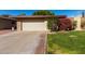 House exterior featuring a beige color scheme and well-maintained lawn at 10322 W Manzanita Dr, Sun City, AZ 85373
