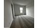 Bedroom with grey carpet and a window offering natural light at 11462 E Utopia Ave, Mesa, AZ 85212