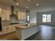 Modern kitchen with island, white cabinets, and tile floors at 11462 E Utopia Ave, Mesa, AZ 85212