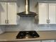 Stainless steel gas cooktop with white shaker cabinets at 11462 E Utopia Ave, Mesa, AZ 85212