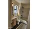 Updated bathroom with subway tile shower, wood vanity, and hexagon floor tile at 12432 W Fieldstone Dr, Sun City West, AZ 85375