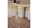 Spacious bedroom with wood-look floors, ceiling fan and large closet at 12432 W Fieldstone Dr, Sun City West, AZ 85375