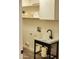 Updated laundry room with utility sink, shelving, and wood-look floors at 12432 W Fieldstone Dr, Sun City West, AZ 85375