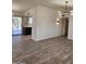 Spacious living room with wood-look floors, view to kitchen and patio at 12432 W Fieldstone Dr, Sun City West, AZ 85375