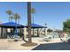 Community pool area with covered seating and palm trees at 12432 W Fieldstone Dr, Sun City West, AZ 85375
