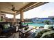 Spacious backyard with a pool, putting green, and covered patio at 15834 S 177Th Ave, Goodyear, AZ 85338