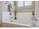 Clean bathroom featuring a bathtub, window, and decorative candles at 15834 S 177Th Ave, Goodyear, AZ 85338