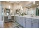 Elegant bathroom with dual vanities, a large mirror, and a walk-in shower at 15834 S 177Th Ave, Goodyear, AZ 85338