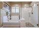 Relaxing bathroom with a soaking tub and a separate shower stall at 15834 S 177Th Ave, Goodyear, AZ 85338