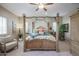 Spacious bedroom with a large bed, comfortable seating, and ample natural light at 15834 S 177Th Ave, Goodyear, AZ 85338