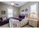 Bedroom with a queen bed, purple accents and ceiling fan at 15834 S 177Th Ave, Goodyear, AZ 85338