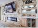 Stone fireplace with built-in shelving and a wine refrigerator at 15834 S 177Th Ave, Goodyear, AZ 85338
