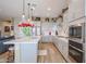 Modern kitchen with white cabinets, a large island, and stainless steel appliances at 15834 S 177Th Ave, Goodyear, AZ 85338