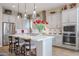 Modern kitchen with white cabinets, a large island, and stainless steel appliances at 15834 S 177Th Ave, Goodyear, AZ 85338