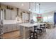 Modern kitchen with white cabinets, a large island, and stainless steel appliances at 15834 S 177Th Ave, Goodyear, AZ 85338