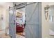 Charming home office with barn doors, comfortable chair, and Beatles memorabilia at 15834 S 177Th Ave, Goodyear, AZ 85338