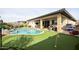 Resort-style backyard with a pool, putting green, and patio at 15834 S 177Th Ave, Goodyear, AZ 85338