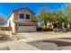 Two-story house with a two-car garage and desert landscaping at 16142 N 102Nd Way, Scottsdale, AZ 85255