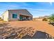 Sunny backyard with desert landscape and home view at 1623 E Hidalgo St, Apache Junction, AZ 85119